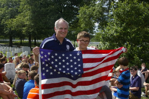 Eric Herzberg Sr. receiving flag as a gift from Mona Shores student